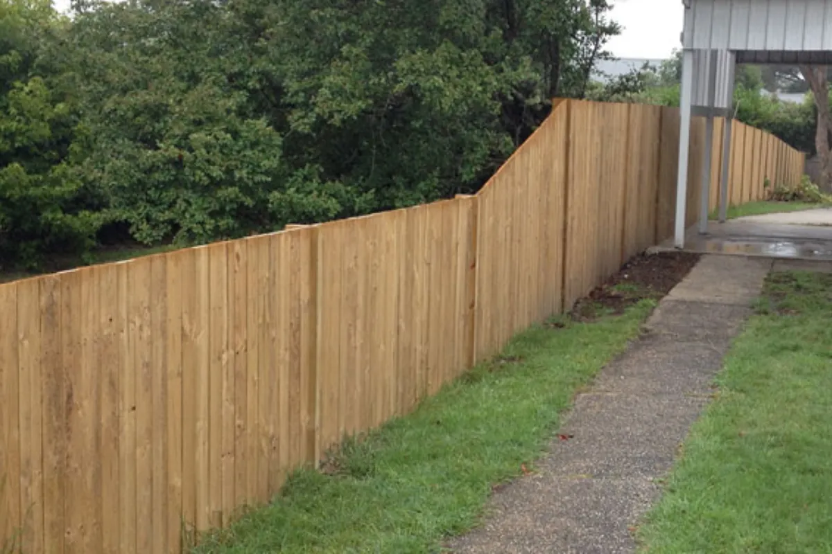 Stepped treated pine paling driveway boundary fence